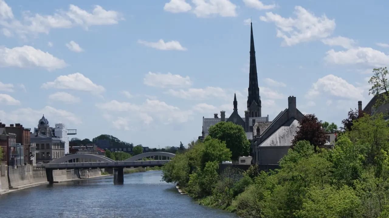 Cambridge, Ontario Grand River with church spire and Main Street bridge — lawn care service area