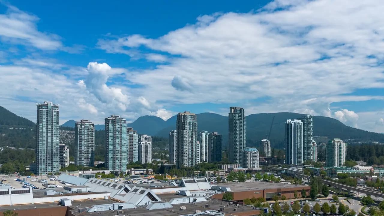 Coquitlam, British Columbia residential towers and city lights at night — lawn care service area