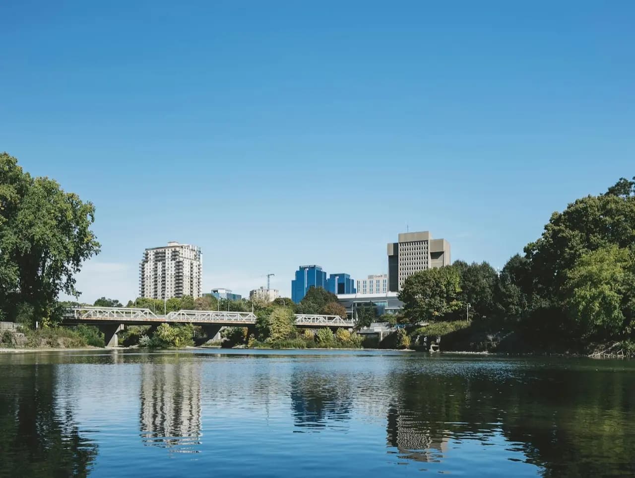 Guelph, Ontario Speed River with downtown skyline and bridge — lawn care service area