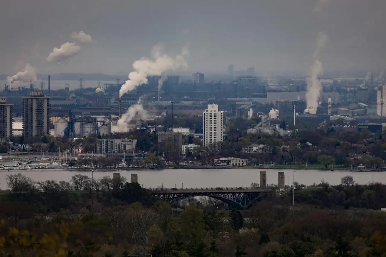 Hamilton, Ontario industrial skyline with steel mills and harbour bridge — lawn care service area